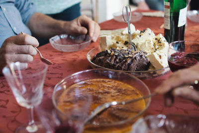 Midsection of man having food at table