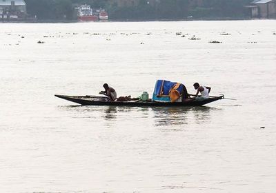 People rowing boat in river