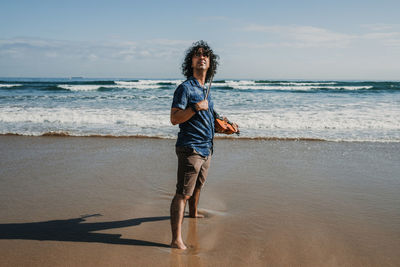 Full length of man at beach against sky