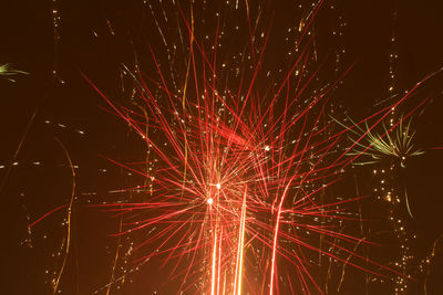 Low angle view of firework display at night