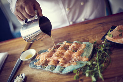 Man preparing food on table