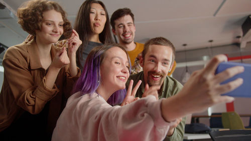 Portrait of happy friends enjoying at home