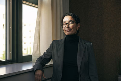 Portrait of young man standing at home