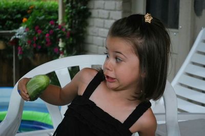 Girl with cucumber making a face