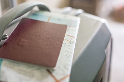 High angle view of luggage with passport and map on floor