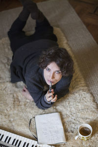 High angle view of woman sitting on book