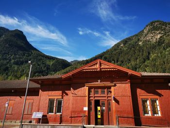 Low angle view of house and mountain against sky