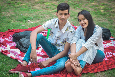 Young couple sitting on grass