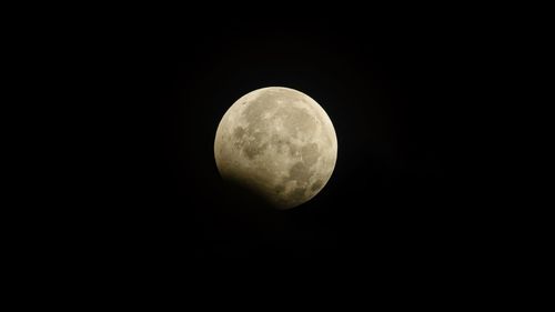 Low angle view of moon against clear sky at night