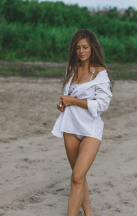 Beautiful woman standing on beach