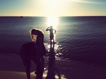 Man standing at beach during sunset