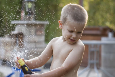 Boy playing with hose