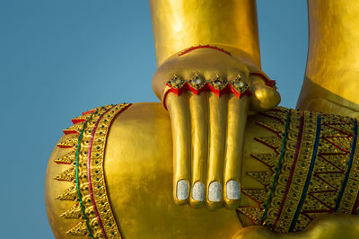 Close-up of metallic sculpture against blue background