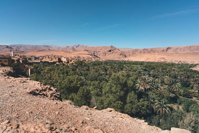 Scenic view of desert against blue sky