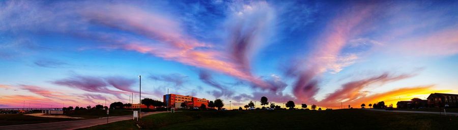 Panoramic view of silhouette buildings against sky during sunset