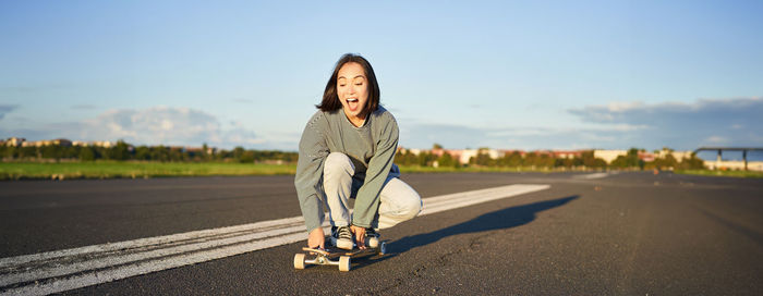 Low section of woman standing on road