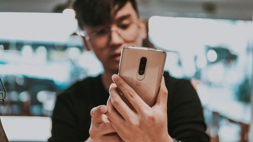 Midsection of man using mobile phone