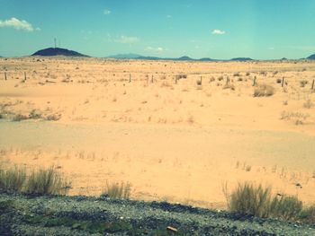 Scenic view of sand dunes against clear sky