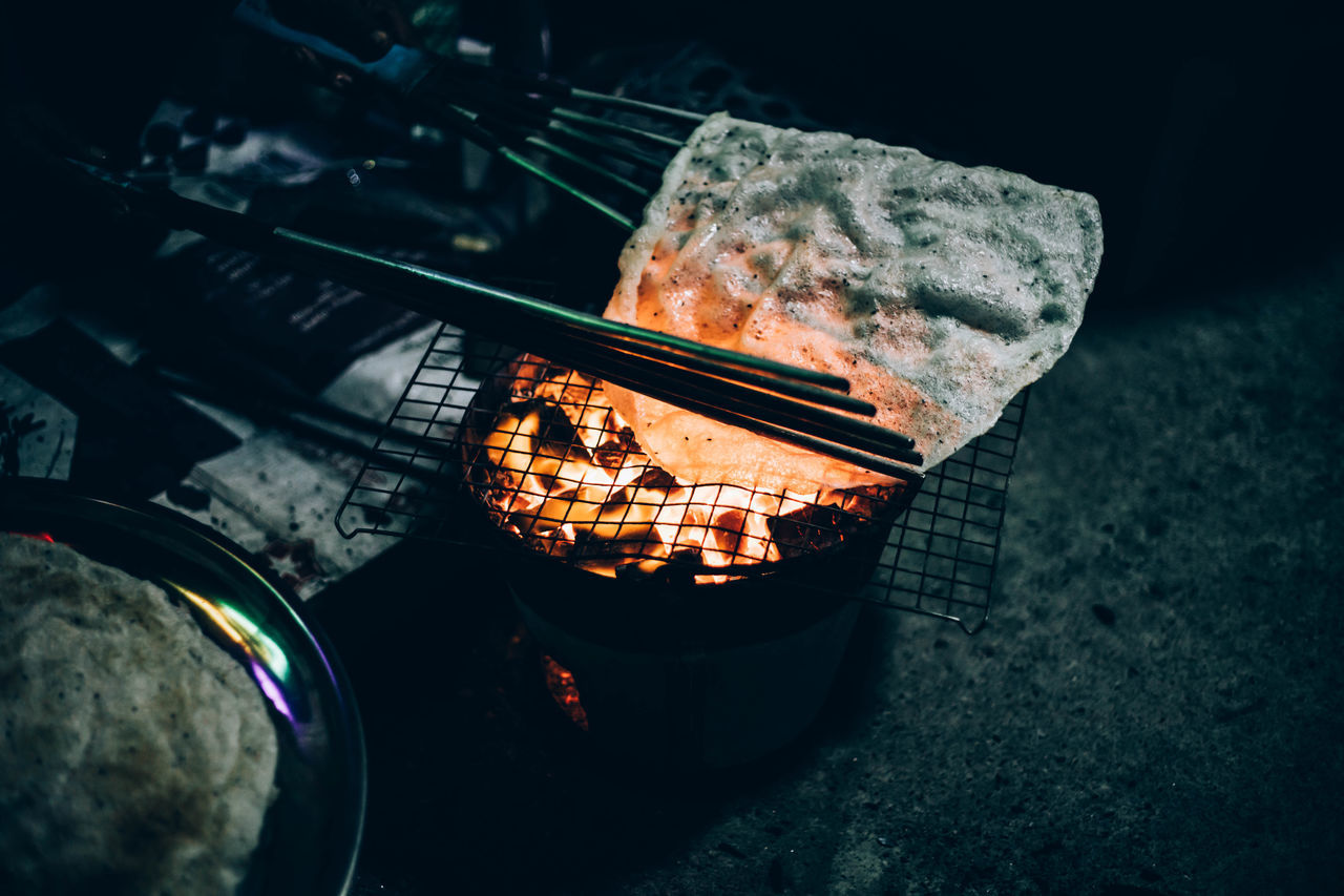 HIGH ANGLE VIEW OF FIRE ON BARBECUE