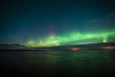 Scenic view of sea against sky at night