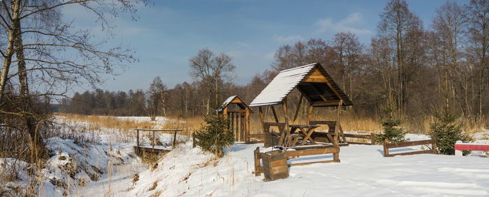 Built structure on snow covered field against sky