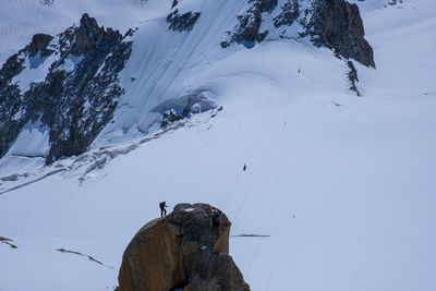 Alpinist climbing aiguille du midi , mont blanc , french alps,  chamonix, haute savoie , france