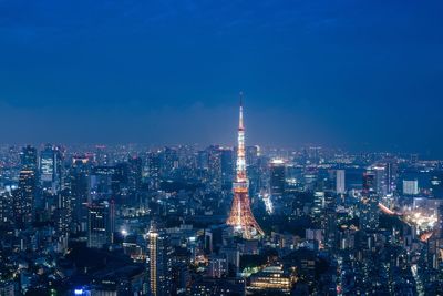 High angle view of city lit up at night