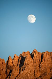 Low angle view of moon against clear blue sky