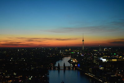 Aerial view of city lit up at night