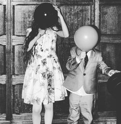 Full length of kids with balloon