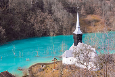 Orthodox church and flooded cemetery next to drowned village at geamana lake near gold mine 