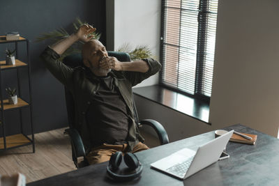 Side view of man working in office