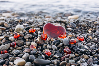 Close-up of heart shape pebbles on beach
