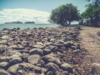 Pebbles on beach against sky