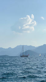 Sailboat in sea against sky
