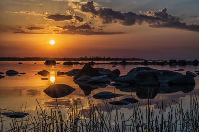 Scenic view of lake against sky during sunset