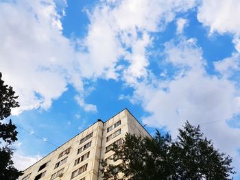 Low angle view of building against cloudy sky