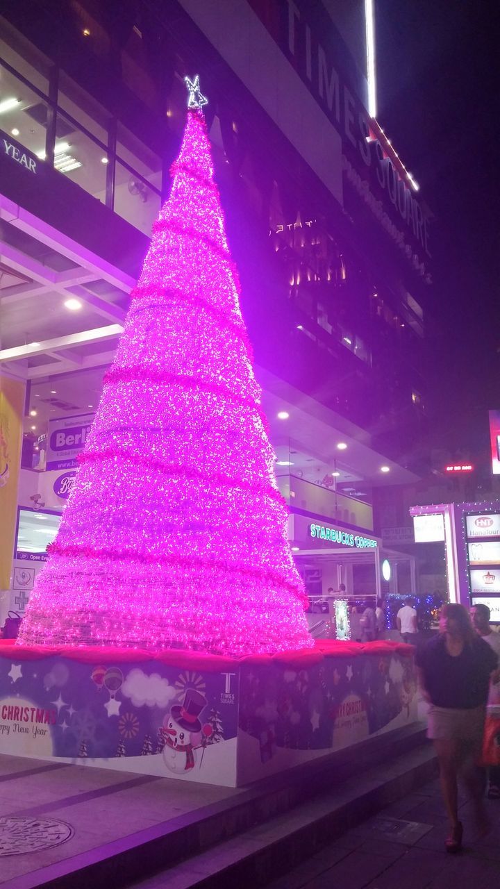 illuminated, night, architecture, building exterior, built structure, celebration, christmas, decoration, city, incidental people, pink color, christmas tree, christmas decoration, indoors, street, lighting equipment, multi colored, store, city life