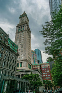 Low angle view of buildings against cloudy sky