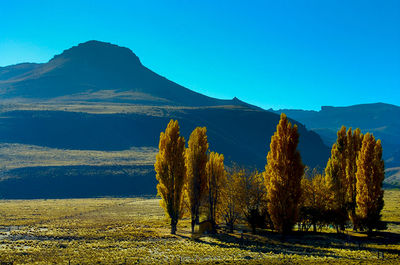 Scenic view of mountains against clear blue sky