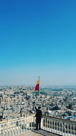 Scenic view of city against clear blue sky