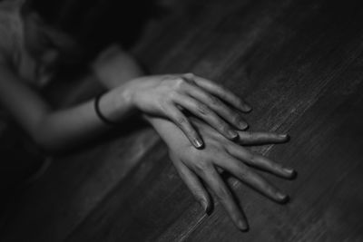 Close-up of hand touching table