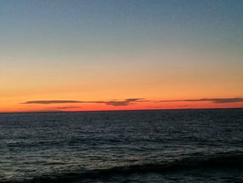 Scenic view of sea against orange sky