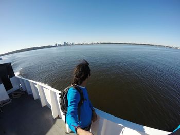 High angle view of man standing on boat deck in sea