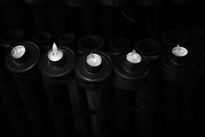 Close-up of lit candles in the dark