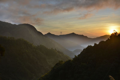 Scenic view of mountains against sky during sunset