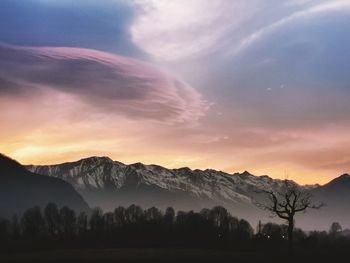 Scenic view of snowcapped mountains against sky during sunset