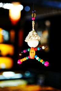 Close-up of illuminated lighting equipment hanging at night