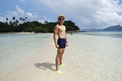 Full length of young man standing at beach