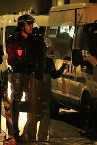 Man standing in car at night